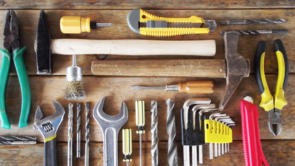 Locksmith tools on wooden background.