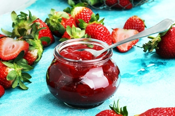 strawberry jam with fresh strawberries. marmalade on spoon and jar