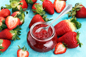 strawberry jam with fresh strawberries. marmalade on spoon and jar