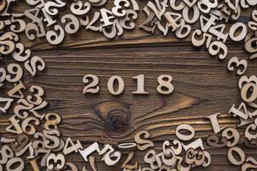 year 2018 on a wooden background surrounded by figures. Business concept idea, calendar calculation, dates, success and achievements in the year