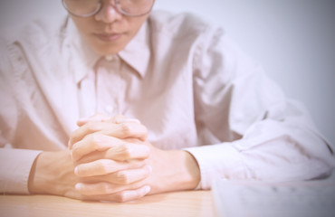 close up, the pastor laid hands on the black book of the Bible, Buddhist, Catholic, Christian, prayer, and pray for blessings from God, all people are safe from harm.