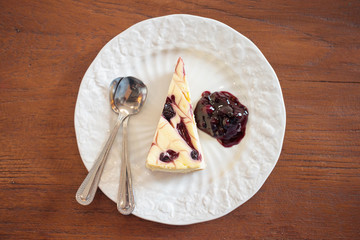 blueberry cheesecake on white plate on wood table