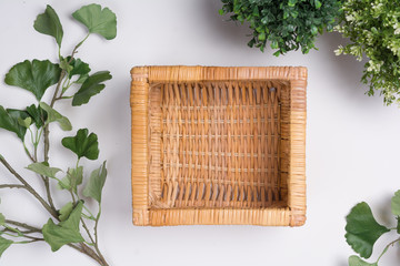 Wicker Basket with Foliage Flat Lay Top View