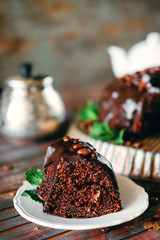Sweet chocolate cake with cacao icing and decorated with mint