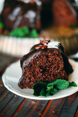Sweet chocolate cake with cacao icing and decorated with mint