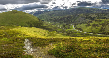Fototapeta na wymiar Scottish landscape. Cairngorm Mountains and Old Military Road A93. Royal Deeside between Braemar and Ballater. Glen Shee, Aberdeenshire, Scotland, UK. 