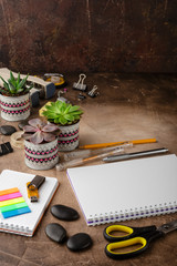 Notepad and succulents on the table. The Business Concept.