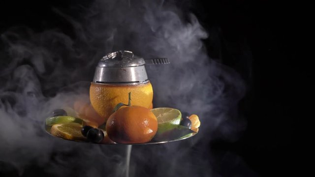 Hookah with ornage bowl and fruits black background isolated
