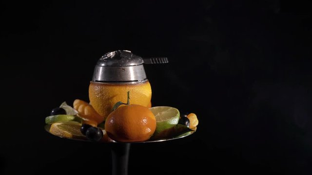 Hookah with ornage bowl and fruits black background isolated