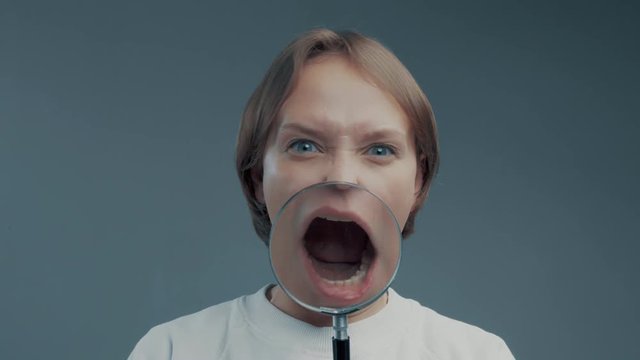 portrait of caucasian wooman with magnifier make ull faces
