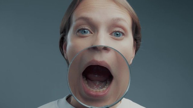 portrait of caucasian wooman with magnifier make ull faces