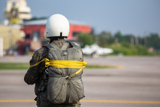 tactical paratrooper in camouflage uniform with T-10 parachute standby at airfield