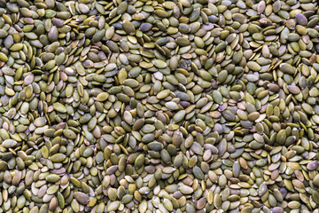 Full frame close-up raw pumpkin seeds in flat lay format
