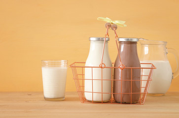 image of milk and chocolate over wooden table. Symbols of jewish holiday - Shavuot.