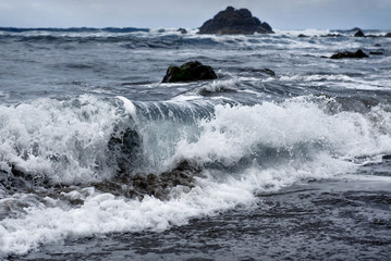 a big wave runs ashore in the ocean