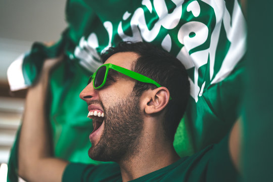 Fototapeta Saudi Arabia fan celebrating with flag