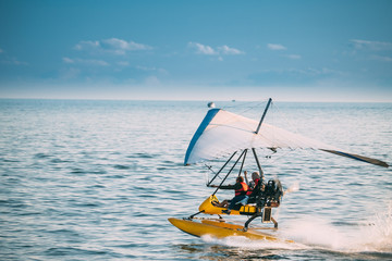 Motorized Hang Glider With Muslim Woman Take Off Frow Sea In Sunny Summer Day