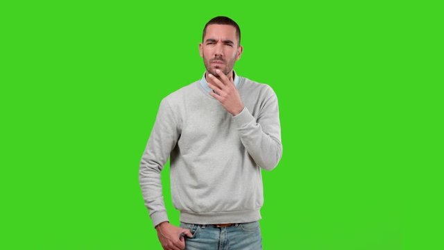 Suspicious guy on green background