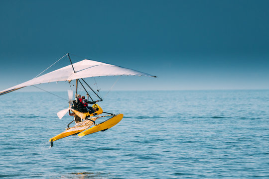 Motorized Hang Glider With Muslim Woman Take Off Frow Sea In Sunny Summer Day