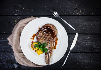 Rib-eye steak with corn.