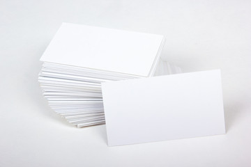 Mockup of business cards fan stack at white textured paper background.