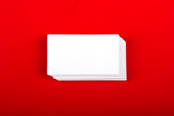 Blank business cards at red textured background. Template for ID. Top view.