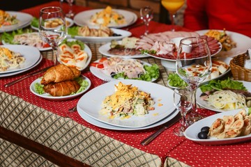 served festive table with salads and appetizers