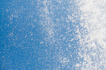 Fototapeta premium Water splashes of stream flow on blue sky background, closeup