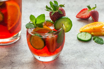 Traditional Pimms cocktail with lemonade, strawberries, cucumber