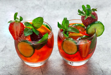 Traditional Pimms cocktail with lemonade, strawberries, cucumber