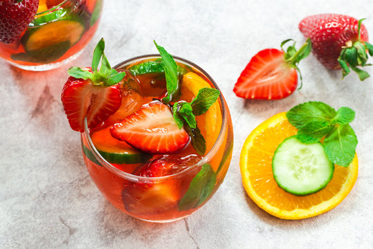 Traditional Pimms cocktail with lemonade, strawberries, cucumber