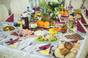 banquet hall of the restaurant, beautifully decorated tables with food	