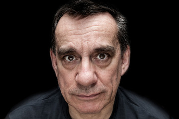 Dramatic portrait of sad unhappy looking man