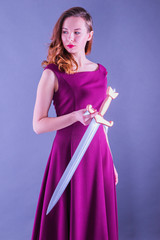 Beautiful young pure princess girl with a sword in neon light
