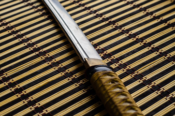 Japanese sword katana on bamboo mat