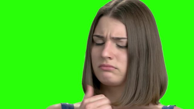 Sad woman caughing, close up portrait. Green screen hromakey background for keying.