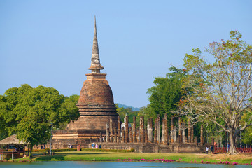 Naklejka premium View of the ruins of the ancient Buddhist temple of Wat Sa Si on a sunny day. Sukhothai Historical Park, Thailand