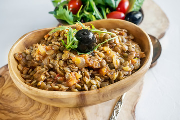 Turkish traditional Lentil salad and a slice of cucumber and green ezogelin, tarhuna.