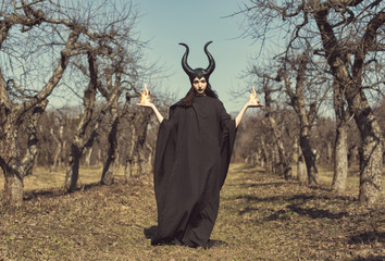 Brunette in a spring apple orchard