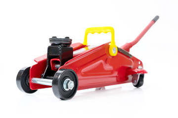 Red hydraulic floor jack isolated on white background