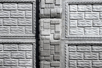 Concrete wall texture made of bricks with various patterns.