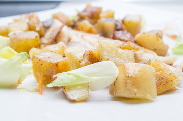 sea bass in the dish with potatoes and salad