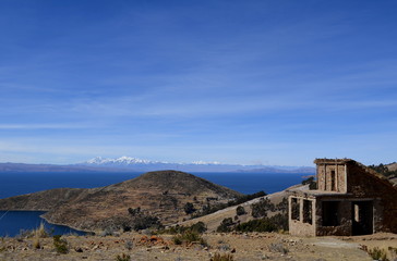 Stone cottage with thatched roof on Isla del Sol in Lake Titicaca, Bolivia.