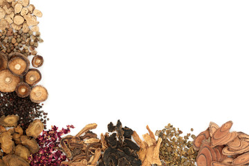 Chinese herbs used in traditional herbal medicine forming a background border on white background. 