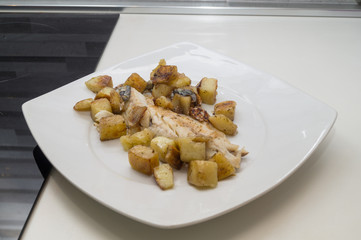 sea bass in the dish with potatoes and salad