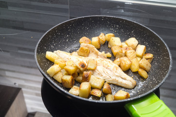 sea bass cooks with potatoes