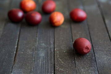 red Easter eggs on dark wooden background