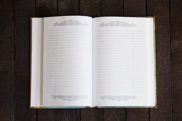 open note book on dark wooden background