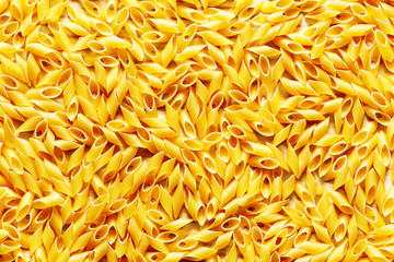 Yellow pasta close up on wood