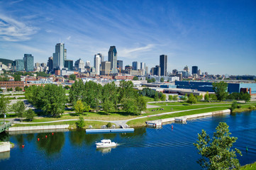 Montreal skyline with yacht in foreground in the Lachine Canal - obrazy, fototapety, plakaty